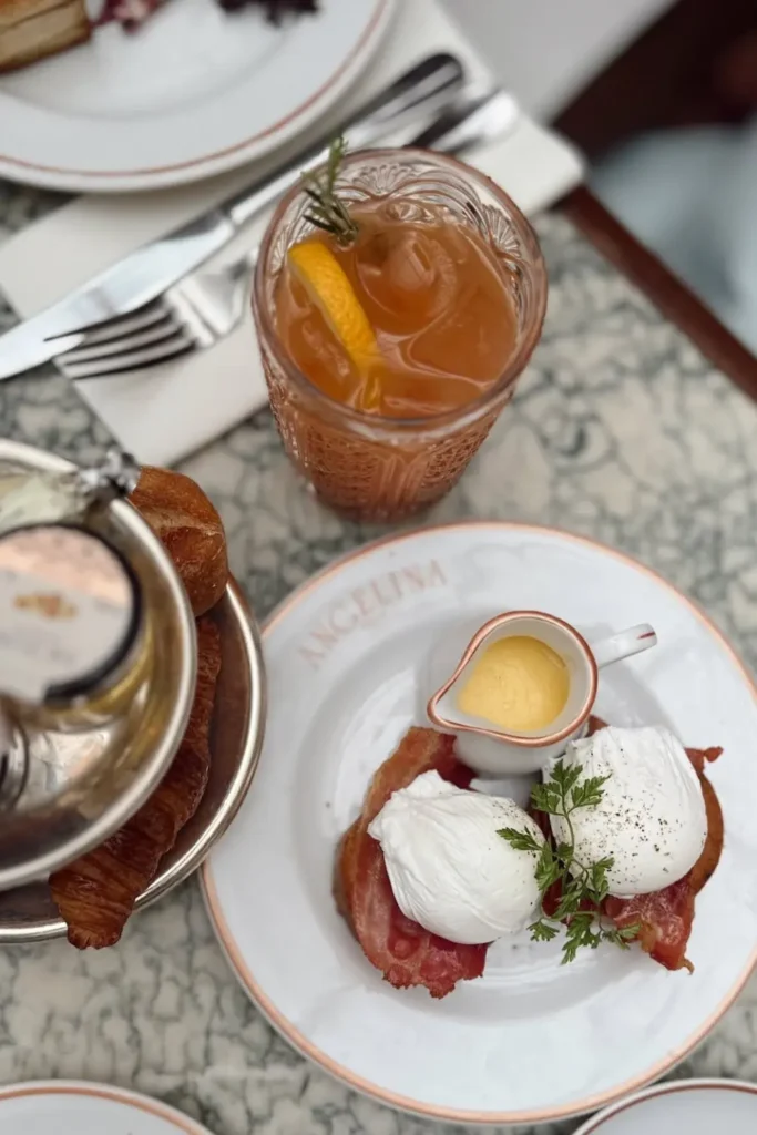 a breakfast scene featuring Eggs Benedict at Angelina Paris